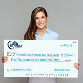 Woman holding Giant Check For Community Garden